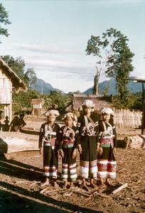 Four Yellow Lahu (Lahu Shi) girls stand in their village in Houa Khong Province