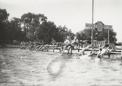 Boys dive into lake at Camp Indianola