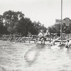 Boys dive into lake at Camp Indianola