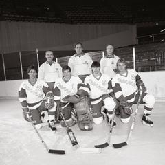 Hockey players and staff on ice