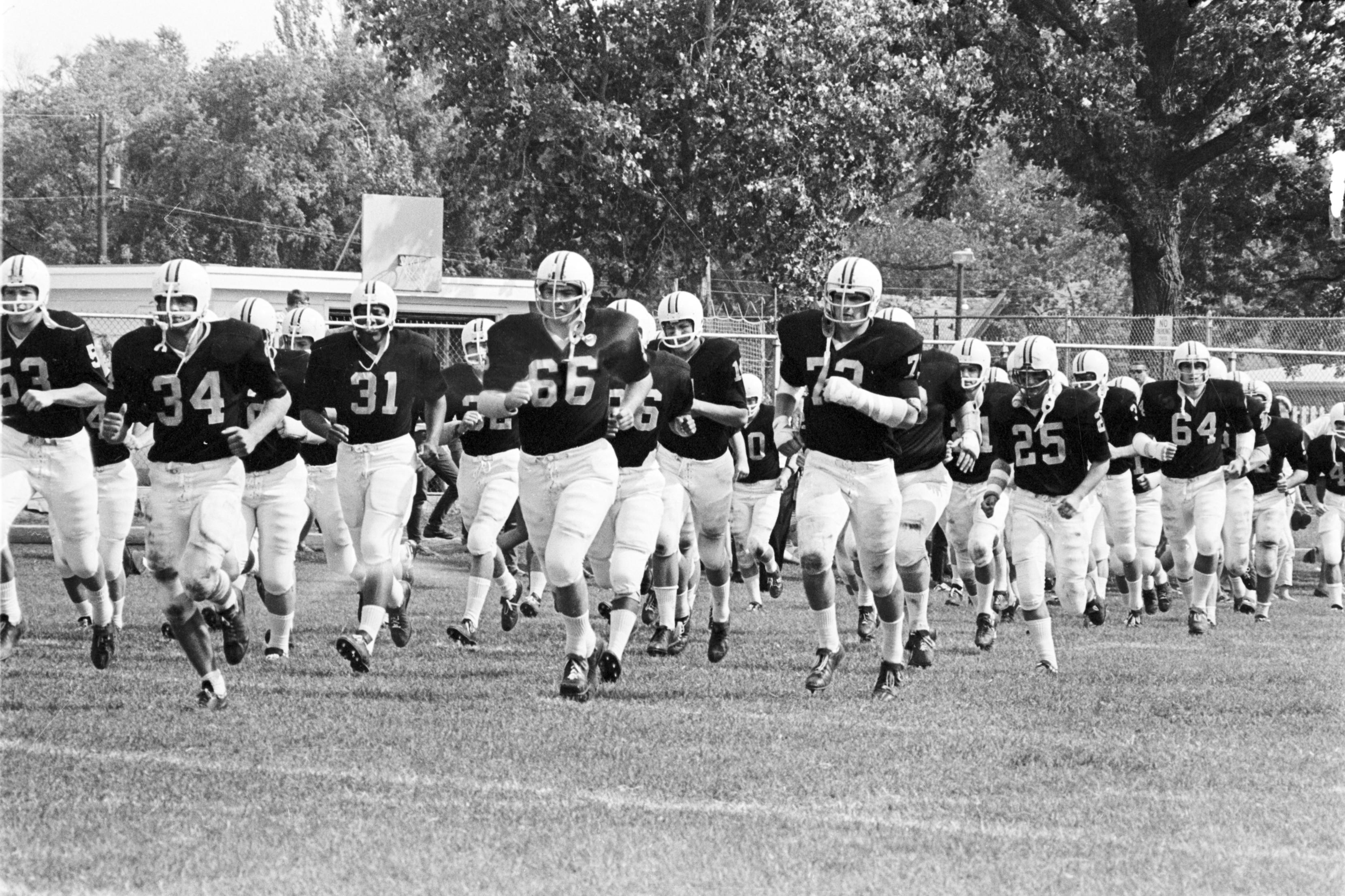 Football team shop running onto field