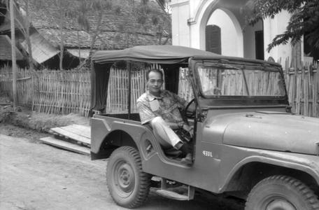 Man in jeep visiting aid mission, outside of residence-office of JMH