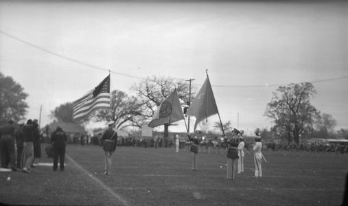 Men carrying flags at football game