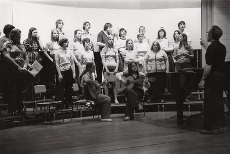 Music professor Pete Ayer conducting a chorus