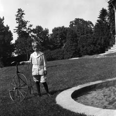 Frederic Leopold standing beside tricycle