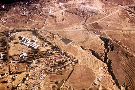 Aerial View of Village and Small Farms at Base of Thaba Bosiu Plateau