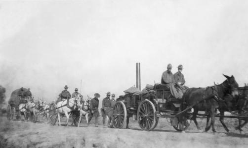 Soldiers of the US Army's 15th Infantry Regiment marching with horse-drawn carts.