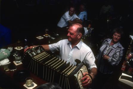 Art Altenburg plays concertina at his bar