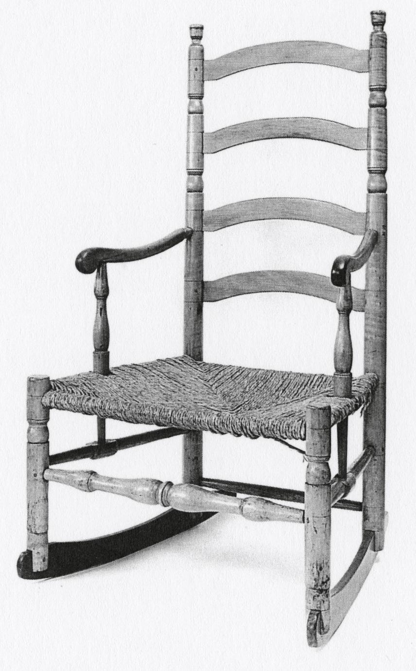 Black and white photograph of a slat-back armchair with rockers.