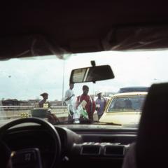 View of street peddlers from car