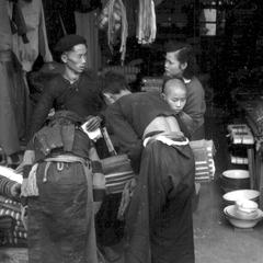 Hmong considering bamboo mats in a Chinese shop