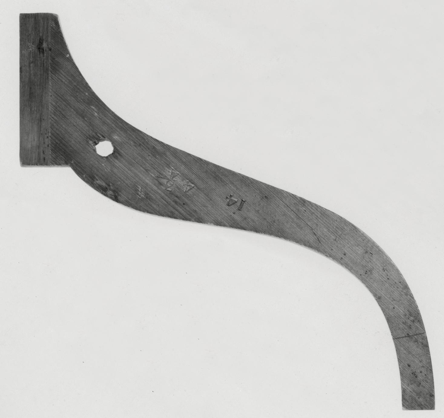 Black and white photograph of a template for stand legs.