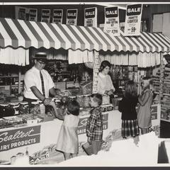 Children line up to buy candy and ice cream at a drugstore candy display