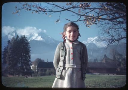 Bavarian child with snow-covered mountains in the background