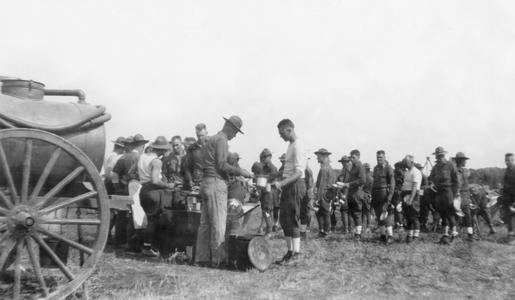 Soldiers of the US Army's 15th Infantry Regiment line up to get food in front of an open air canteen.