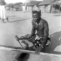 Kuba-Ngongo Man Carving a Paddle