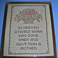 "In heaven" cross-stitched sampler with flowers