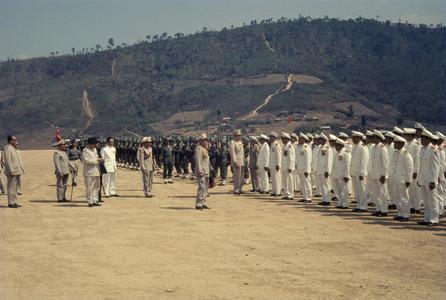 The King of Laos inspects soldiers and officials with dignitaries