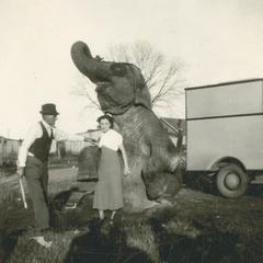 Circus elephant with trainer and woman
