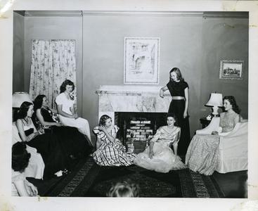 Alpha Phi members sitting in living room in formal dresses