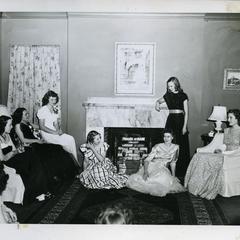 Alpha Phi members sitting in living room in formal dresses