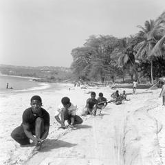 Men on the Beach Arranging Net for Ocean Fishing