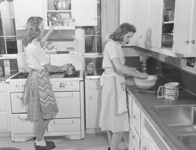 Students in the home management house kitchen