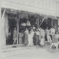 Filipino men and women standing in front of a sari-sari store