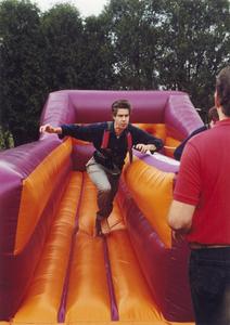 Music professor Peter Gibeau running through inflatable obstacle course