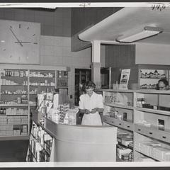 Pharmacy staff work at the prescription counter