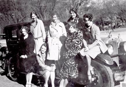 Women sitting on a car
