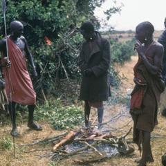 Samburu Men Cooking Meat of a Cow Killed with Spears
