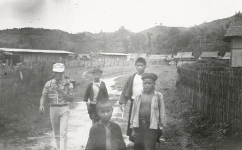 Four Akha youth walk through Muang Meung in Houa Khong Province