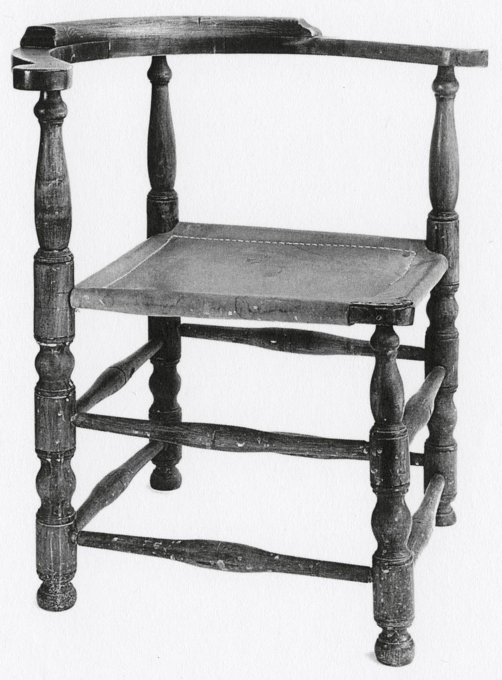 Black and white photograph of a corner chair.