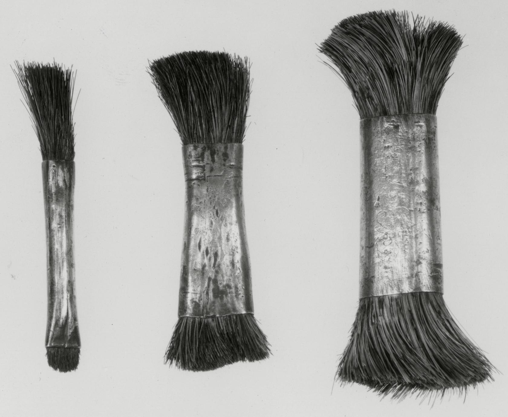 Black and white photograph of various brushes.