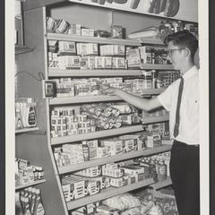 Man stands in front of a drugstore first aid display
