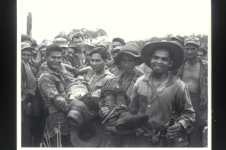 Filipino civilians bring in a Japanese prisoner, Mindanao, 1945