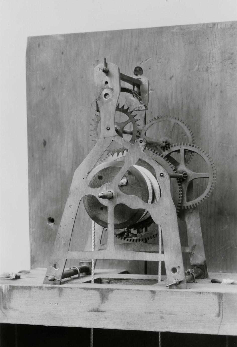 Black and white photograph of a timepiece gear system.