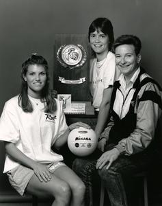 Women volleyball players holding award