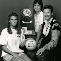 Women volleyball players holding award
