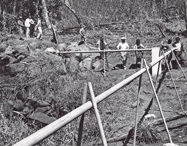 The District Chief and villagers inspect the pipes that carry the water to Houei Kong in Attapu Province