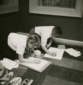 Students drawing during "Let's Draw" radio program