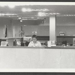 Library staff member at work behind circulation desk