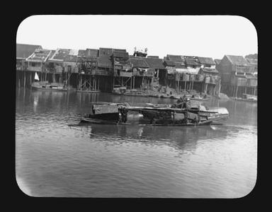 Chinese houses on stilts and river boats.