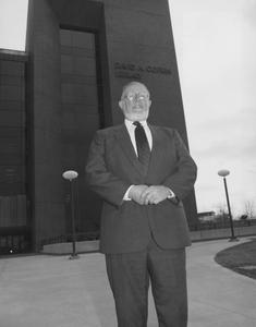 David A. Cofrin standing in front of the David A. Cofrin Library