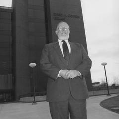 David A. Cofrin standing in front of the David A. Cofrin Library