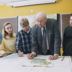 Professor Bill Laatsch and students reviewing maps