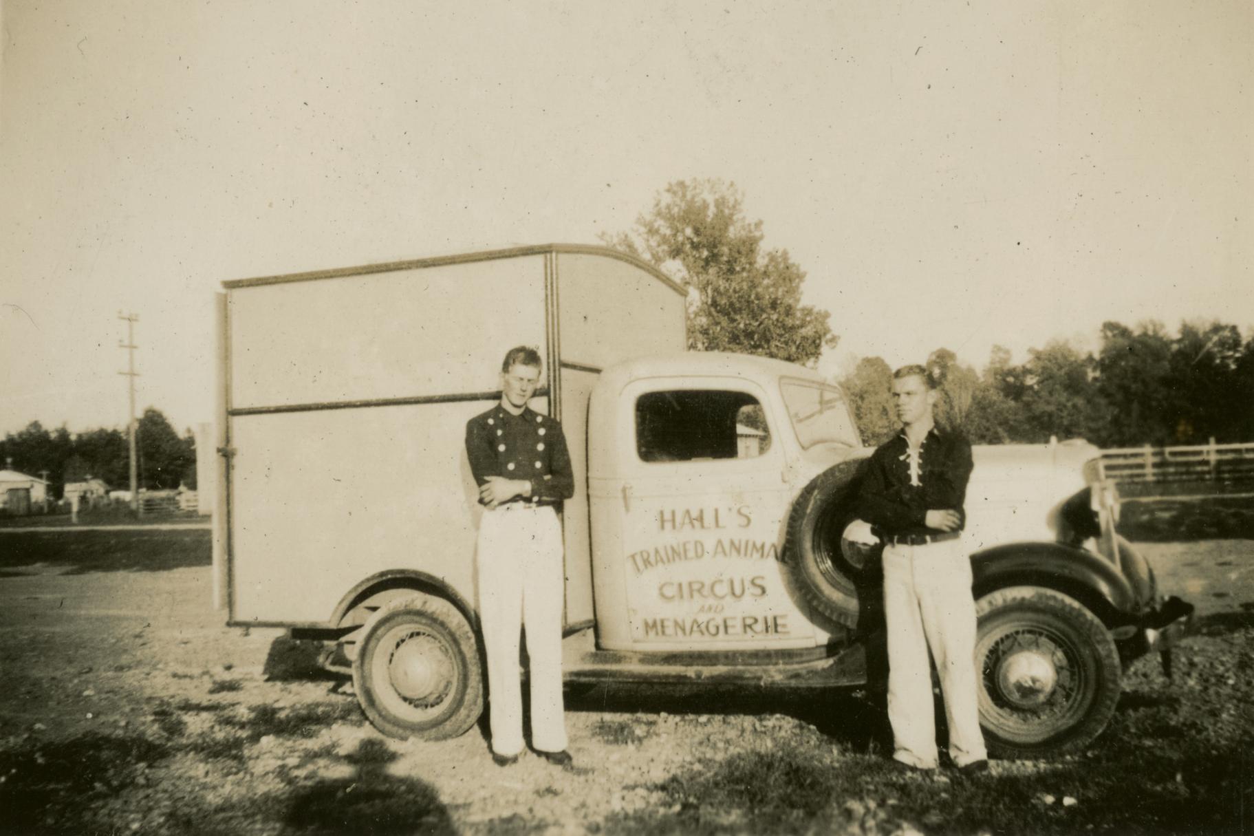 Circus performers standing by truck