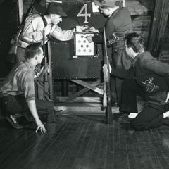 Rifle Club - four members looking at a target
