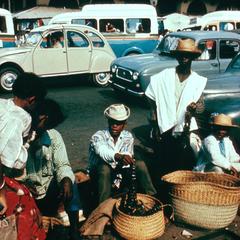 Scene of Basket-Selling in the Zoma Market in Tananarive  with Citroen Cars in Background